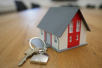 white-and-red-wooden-house-miniature-on-brown-table.jpg white and red wooden house miniature on brown table